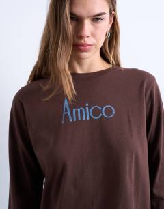 Model wearing Amico graphic boxy long sleeve tee in brown