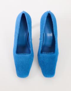 Model wearing Amos chiselled banana heel court shoe in blue hair on real leather