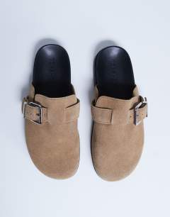 Model wearing Amy slip on mule with buckle in beige