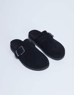 Model wearing Amy slip on mule with buckle in black hair on real leather