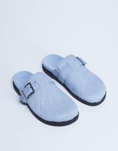 Model wearing Amy slip on mule with buckle in light blue hair on real leather 