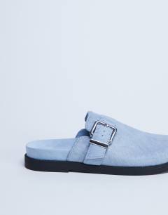 Model wearing Amy slip on mule with buckle in light blue hair on real leather 