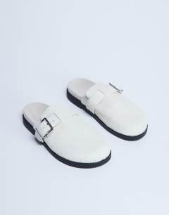 Model wearing Amy slip on mule with buckle in neutral hair on real leather