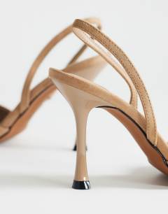 Model wearing Angel faux suede heeled court shoe in taupe