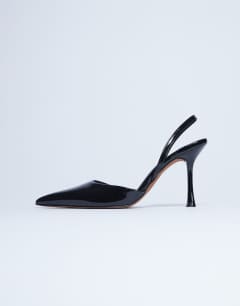 Model wearing Angel heeled court shoe in black patent