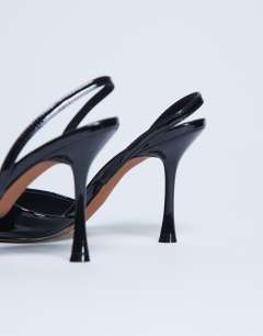 Model wearing Angel heeled court shoe in black patent