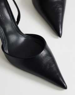 Model wearing Angel heeled court shoe in black