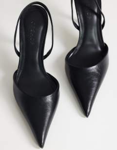 Model wearing Angel heeled court shoe in black