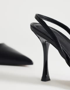 Model wearing Angel heeled court shoe in black