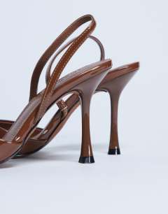 Model wearing Angel heeled court shoe in tan patent