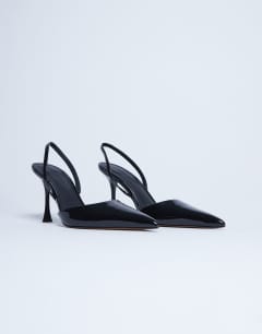 Model wearing Angel high heeled court shoe in black patent