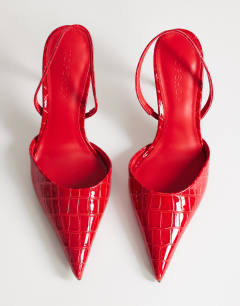 Model wearing Angel high heeled court shoe in patent red croc