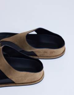 Model wearing Angela toe thing footbed flat sandal in taupe