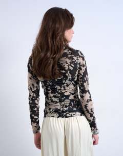 Model wearing Animal mono spot print ruched long sleeve top in black