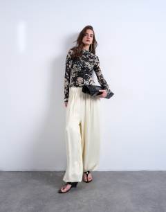 Model wearing Animal mono spot print ruched long sleeve top in black