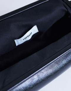 Model wearing Anna angular clutch bag in black