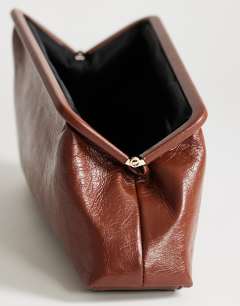 Model wearing Anna angular clutch bag in chocolate