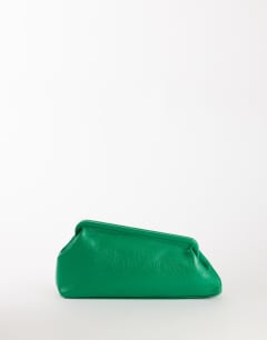 Model wearing Anna angular clutch bag in green