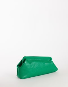 Model wearing Anna angular clutch bag in green