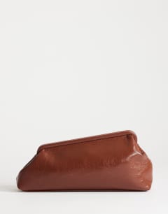 Model wearing Anna angular clutch bag in tan