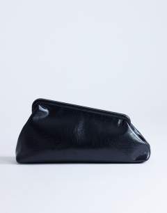 Model wearing Anna medium angular clutch bag in black