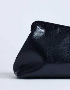 Model wearing Anna medium angular clutch bag in black