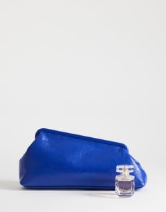Model wearing Anna medium angular clutch bag in cobalt 