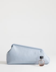 Model wearing Anna medium angular clutch bag in cornflower blue