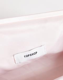 Model wearing Anna medium angular clutch bag in pale pink satin
