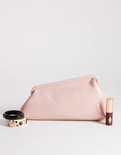 Model wearing Anna medium angular clutch bag in pink