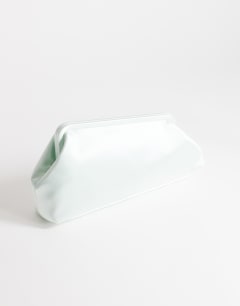 Model wearing Anna medium angular clutch bag in sage satin