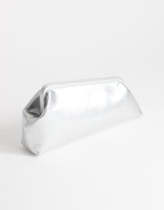 Model wearing Anna medium angular clutch bag in silver