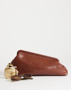 Model wearing Anna medium angular clutch bag in tan