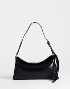 Model wearing Annabel small shoulder bag in black