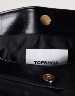 Model wearing Annabel small shoulder bag in black