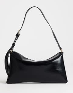 Model wearing Annabel small shoulder bag in black