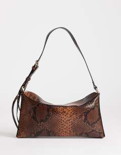 Model wearing Annabel small shoulder bag in snake