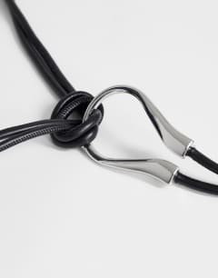 Model wearing Annie hardware tie belt in black and silver
