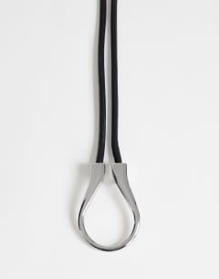 Model wearing Annie hardware tie belt in black and silver