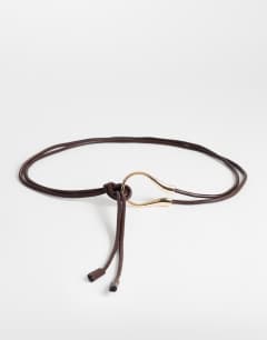 Model wearing Annie hardware tie belt in chocolate and gold