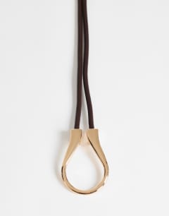 Model wearing Annie hardware tie belt in chocolate and gold