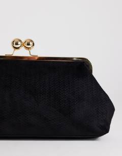 Model wearing Annie weave clutch in  black