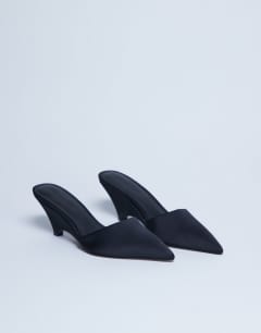Model wearing Annie wedge closed toe shoe in black