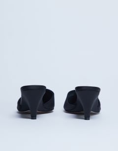Model wearing Annie wedge closed toe shoe in black
