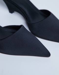 Model wearing Annie wedge closed toe shoe in black