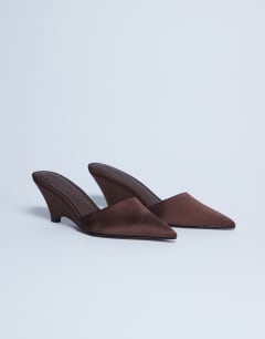 Model wearing Annie wedge closed toe shoe in chocolate