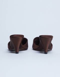 Model wearing Annie wedge closed toe shoe in chocolate