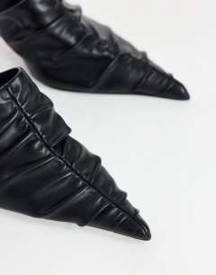 Model wearing Ansel ruched pointed mid heel court shoe in black