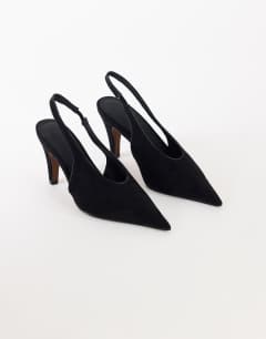 Model wearing Arabella cone heel sling back court shoe in black