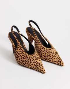Model wearing Arabella cone heel sling back court shoe in deer print